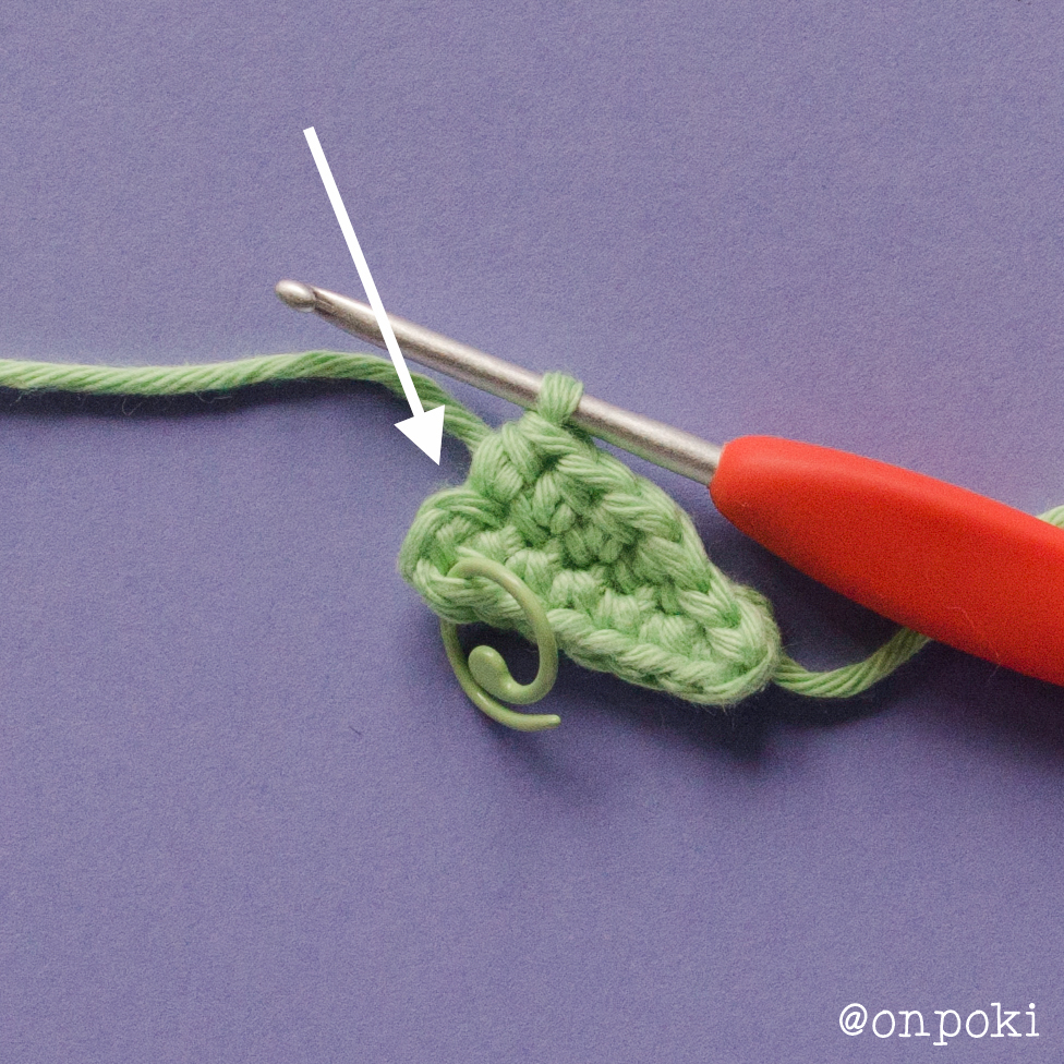 Crochet step showing where to insert the hook for Grogu's ear