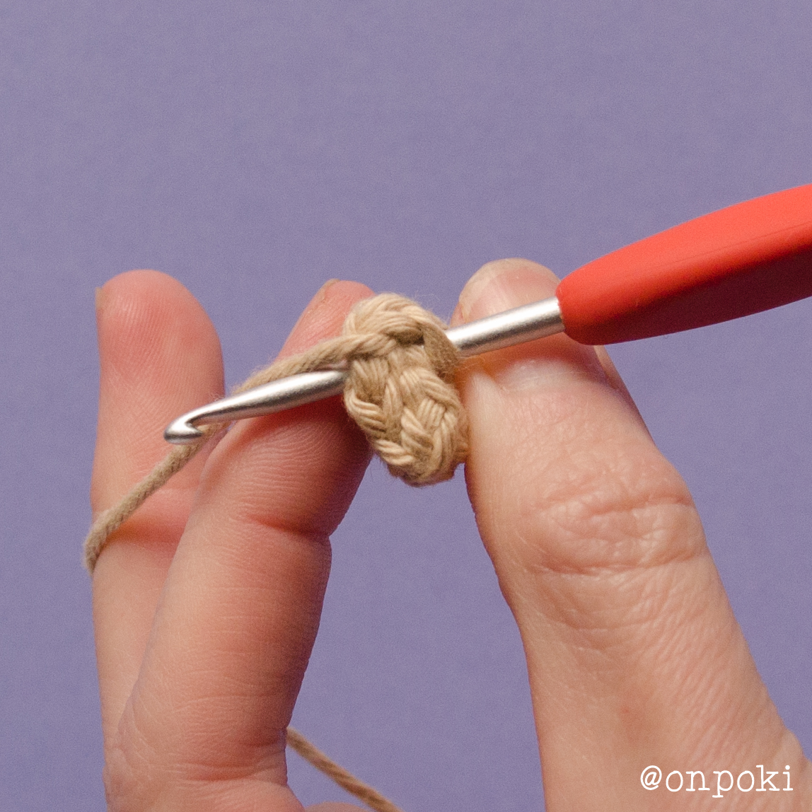 Folding Grogu's arm to close with slip stitches