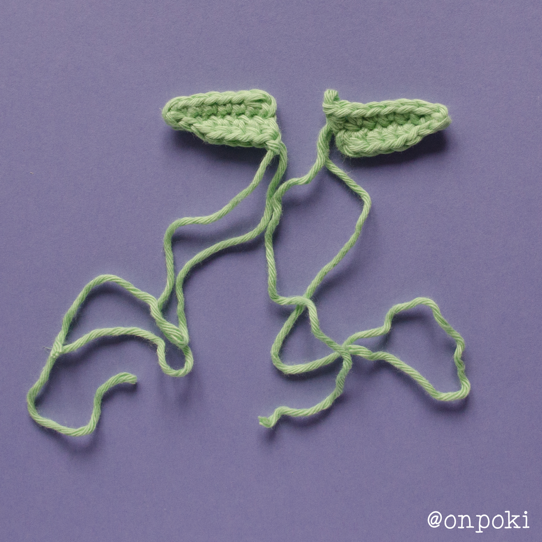 Finished ears for Grogu in green yarn